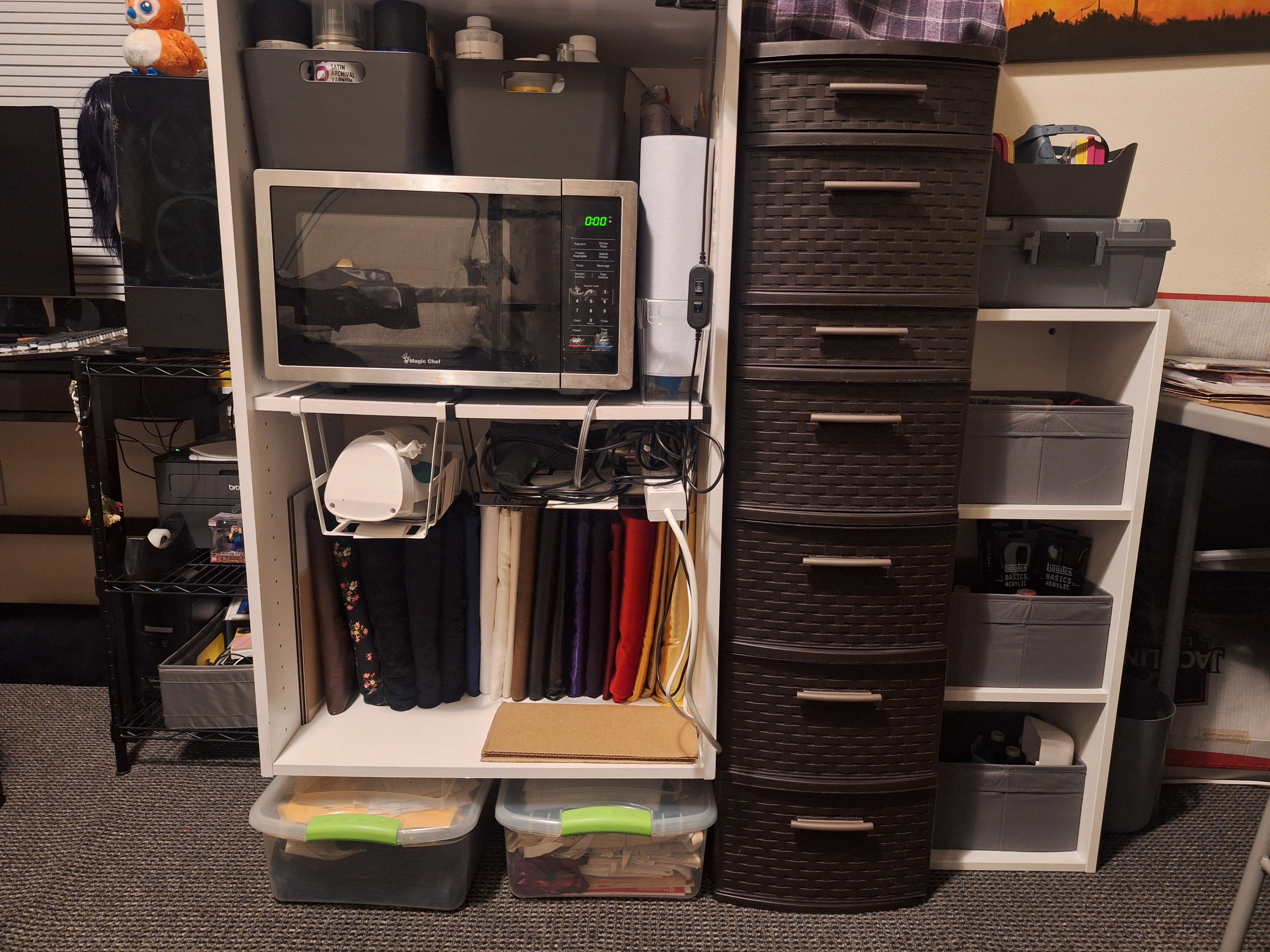 Small bolts of fabric on shelf